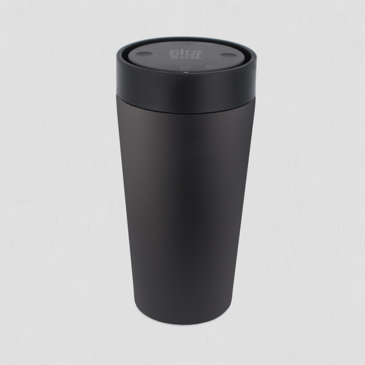 A matte black thermal travel tumbler with a matching black screw-on lid, shown on a light gray background.