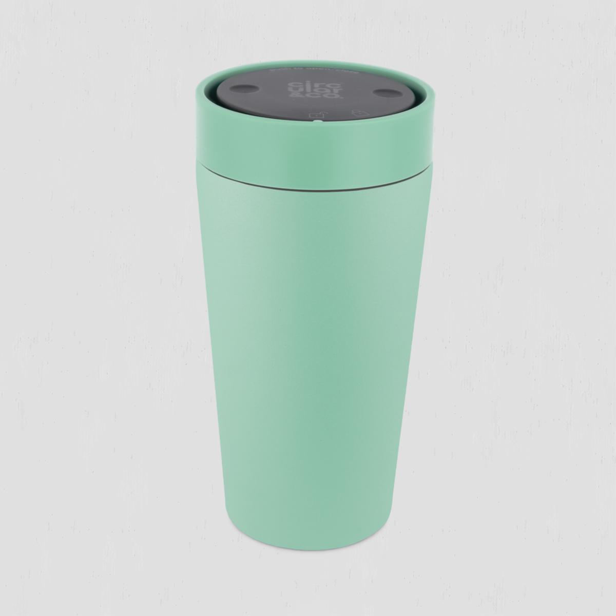 A mint green stainless steel travel cup with a dark gray lid, shown on a light gray background.