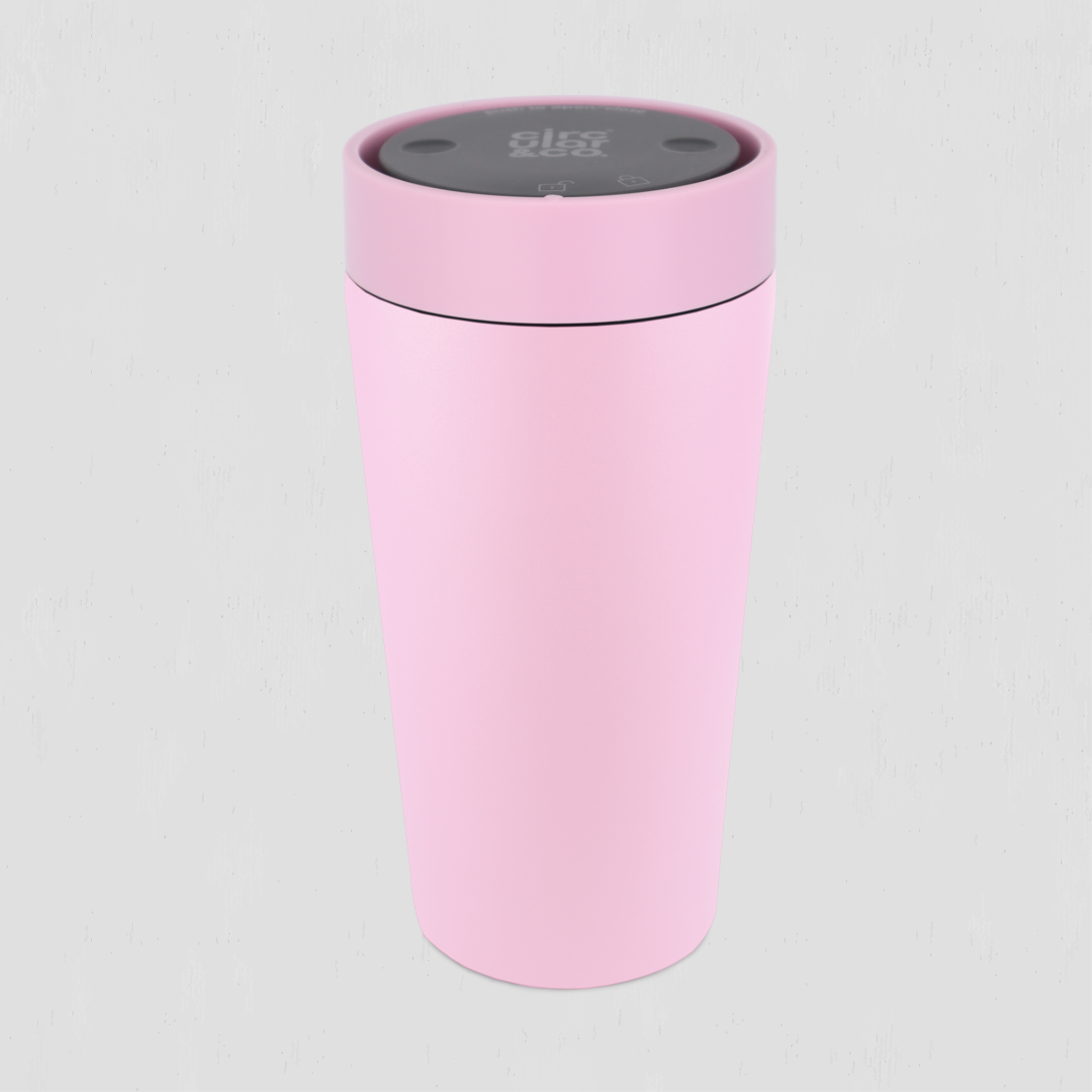 A light pink travel tumbler with a matching pink lid and a dark gray top control panel, shown on a light gray background.