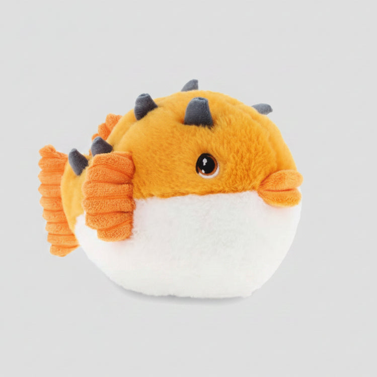 A plush toy puffer fish with an orange body, white belly, orange fins, and dark gray spikes, photographed on a clean white background.