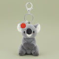 Plush koala keychain with a red flower on a white background