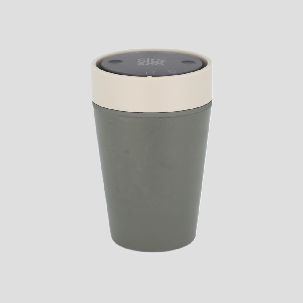 A matte gray travel tumbler with a cream-colored rim and a dark gray lid, shown on a solid light gray background.