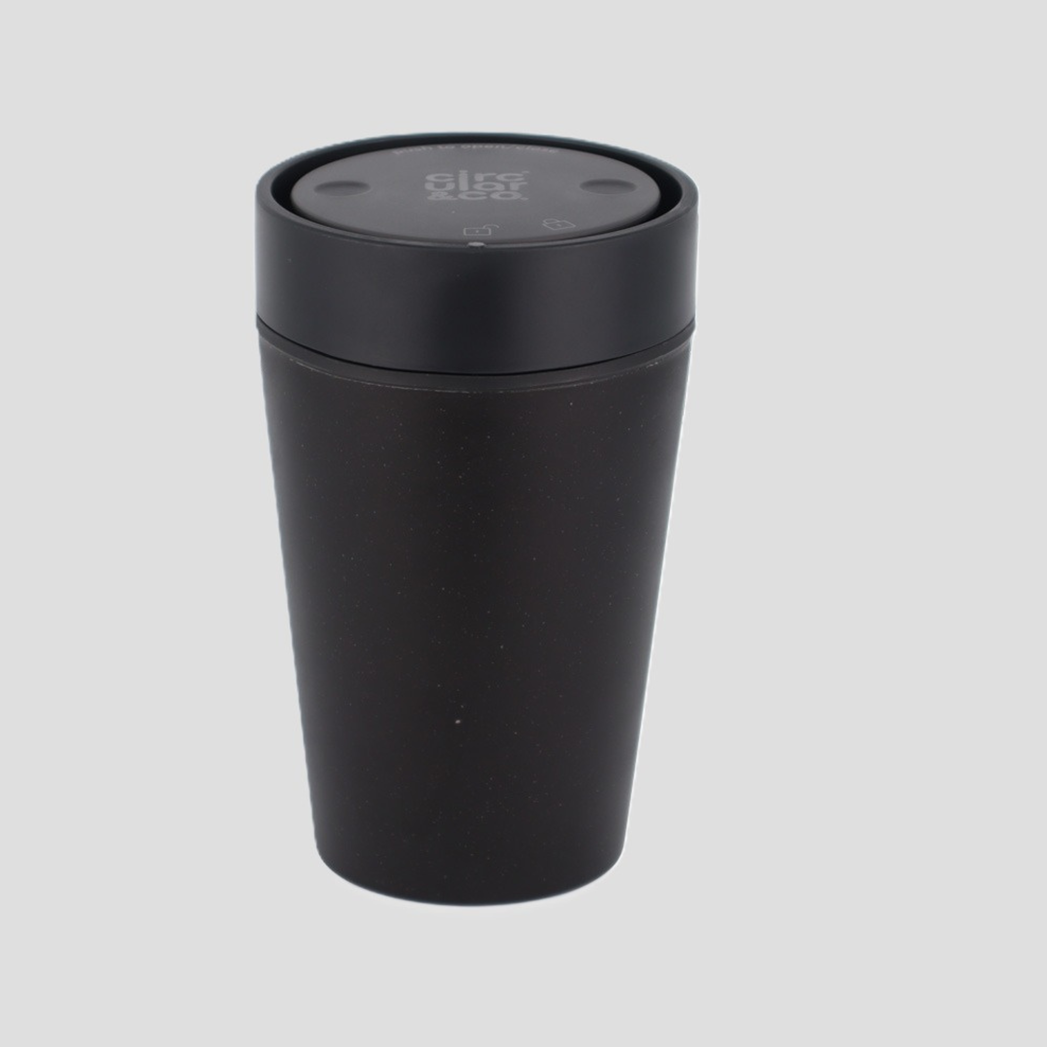 A matte black travel tumbler with a matching black screw-on lid, shown on a solid light gray background.