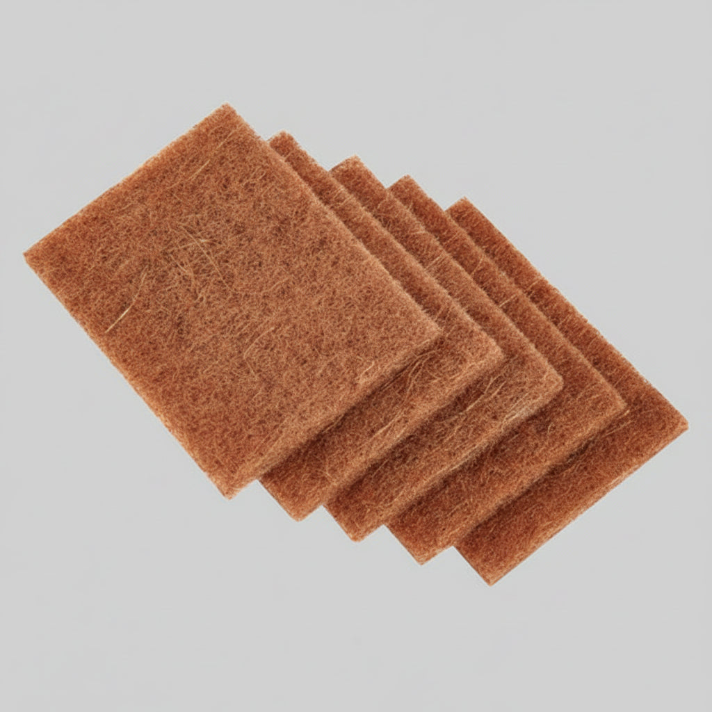 Set of five coconut scrub pads on a white background