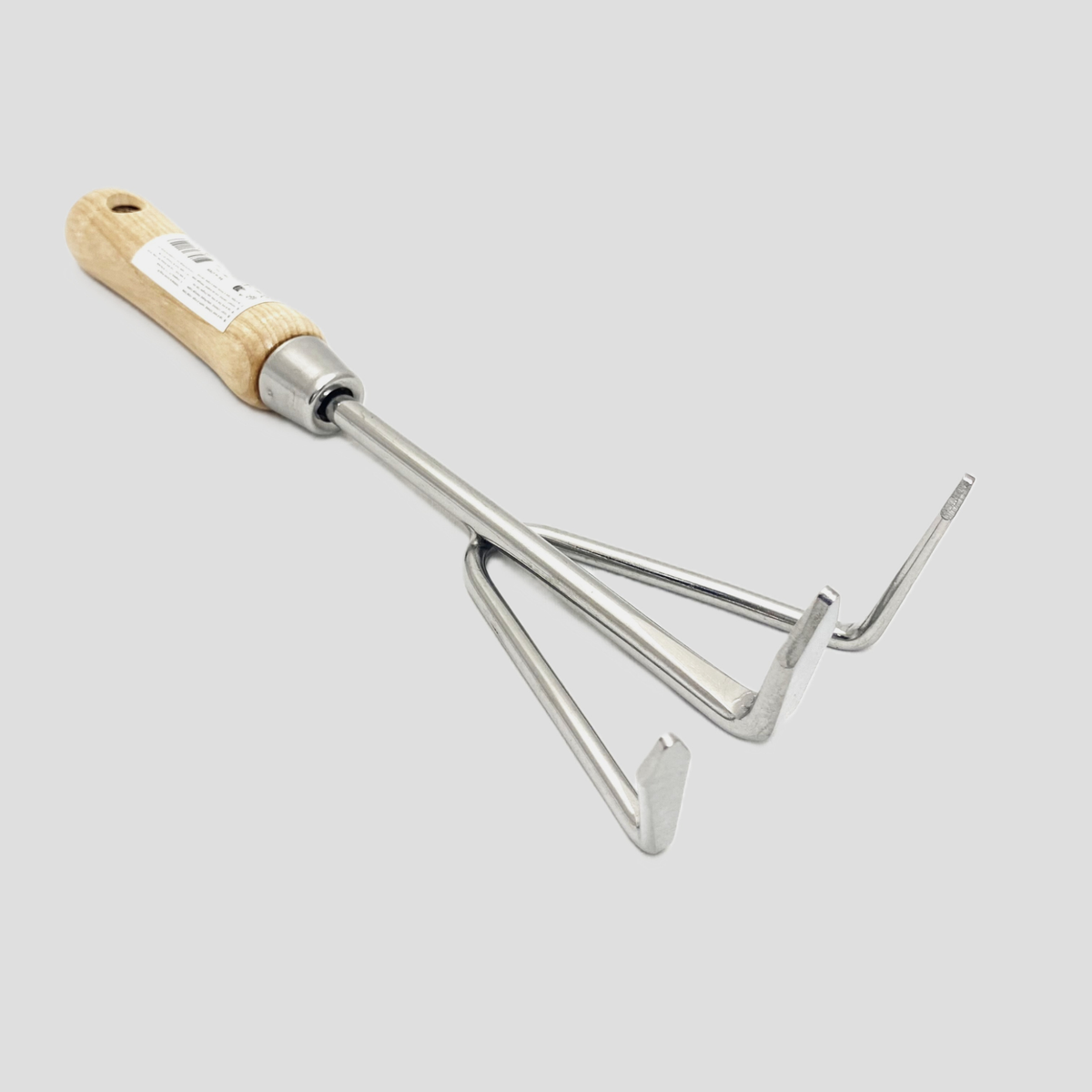 A garden hand fork with a light natural wood handle and a silver metal head, shown on a solid light gray background.