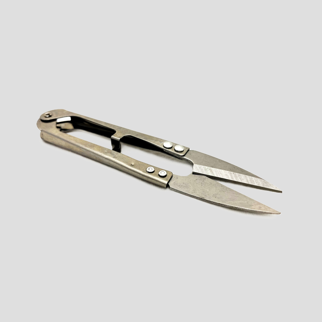 A pair of  metal scissors/ snips with a brushed silver finish 