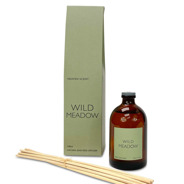 Wild meadow scented reed diffuser. Amber glass bottle and bundle of reeds 
