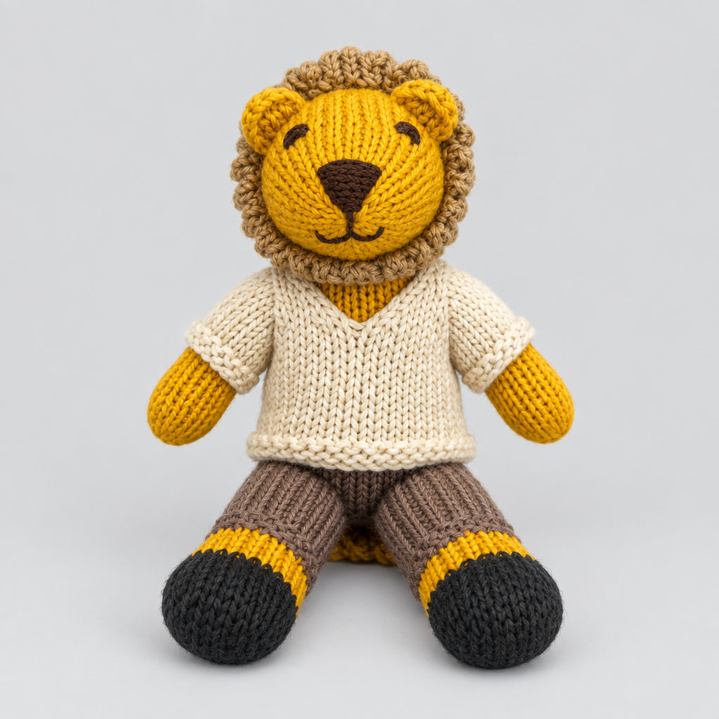 A hand-knit lion doll wearing a cream sweater, brown pants, and yellow-and-black socks.