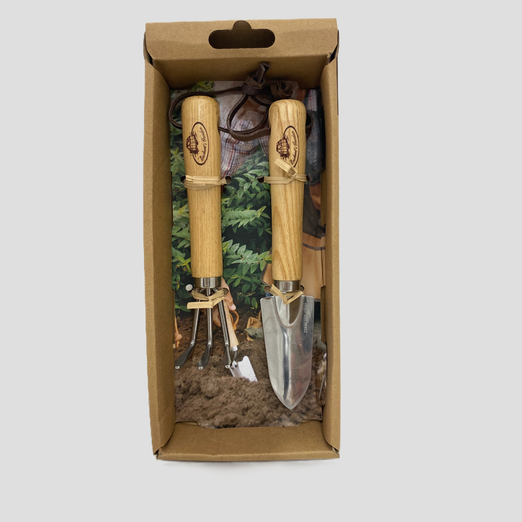 A 2-piece gardening tool set with wooden handles and stainless steel blades, presented inside its brown cardboard packaging box against a light gray background.