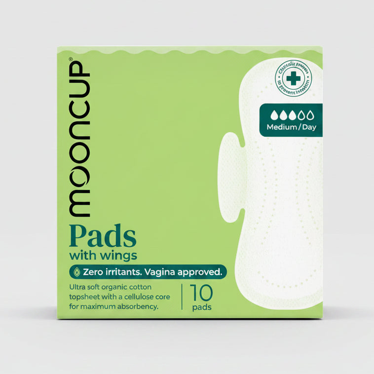 A package of Mooncup Pads with wings, featuring a light green box with a white sanitary pad illustration and text indicating it contains 10 pads and is medium/daily absorbency.
