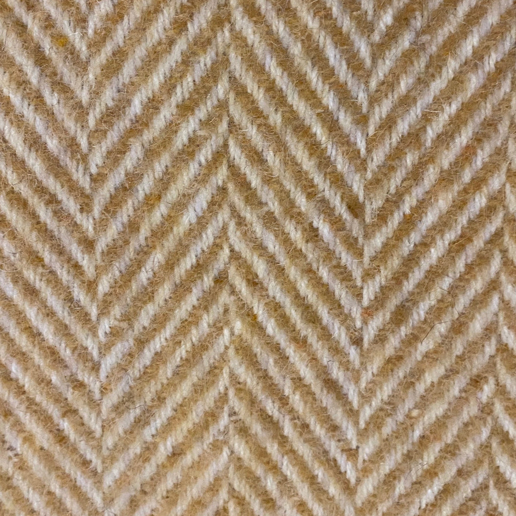 Textured fabric with a herringbone pattern in beige and gold tones.