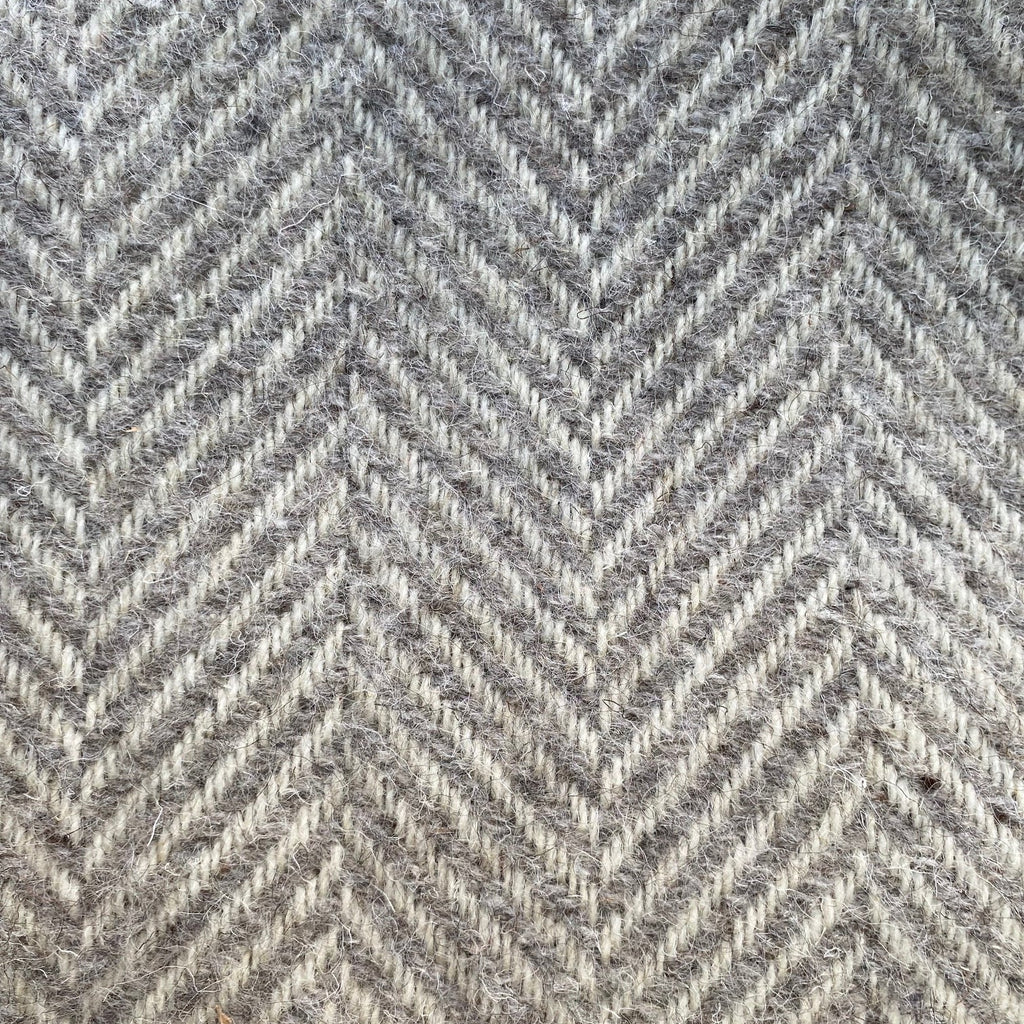 Close-up of a gray blanket with a herringbone pattern