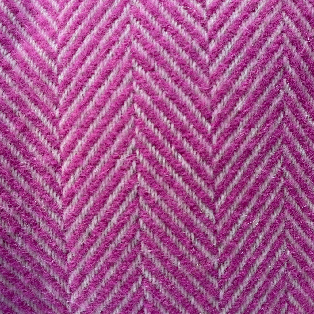 Close-up of pink and gray herringbone pattern blanket