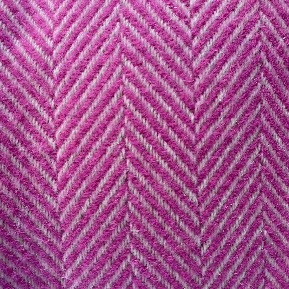 Close-up of pink and gray herringbone pattern blanket