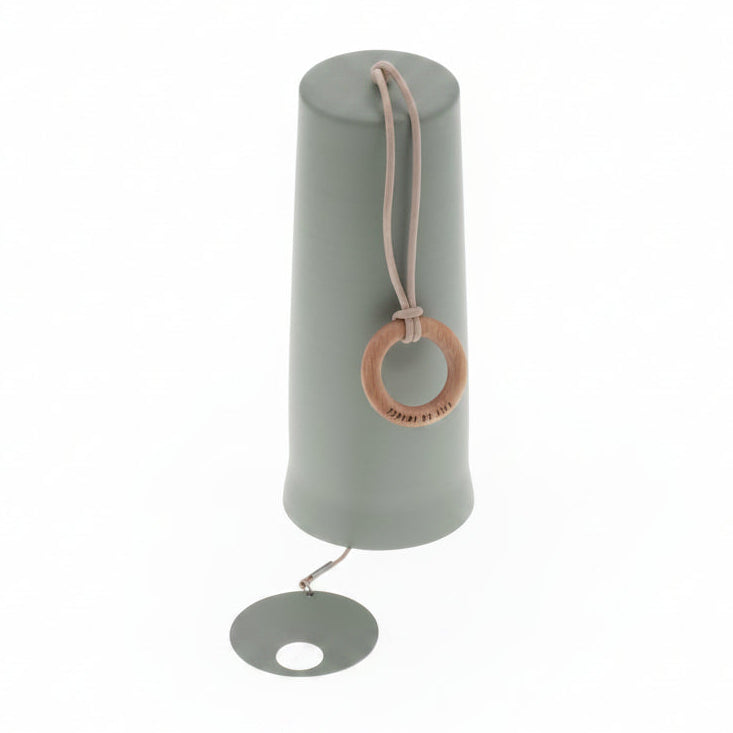 Green metal windchime with a wooden hanging ring on a white background