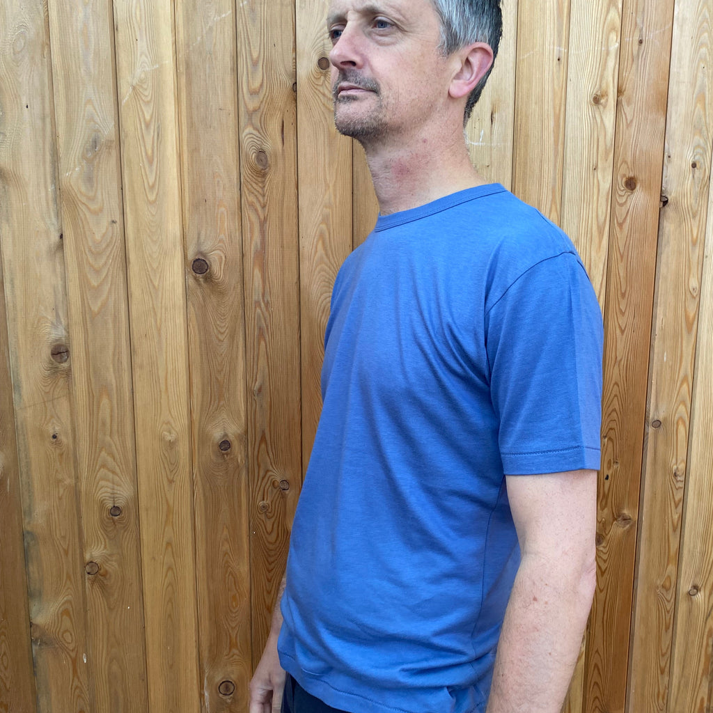 a man wearing a sky blue t shirt