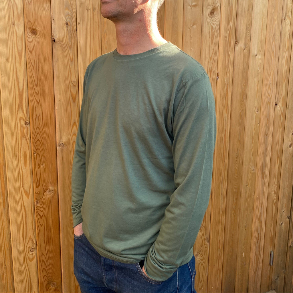A man in a long sleeve olive tshirt