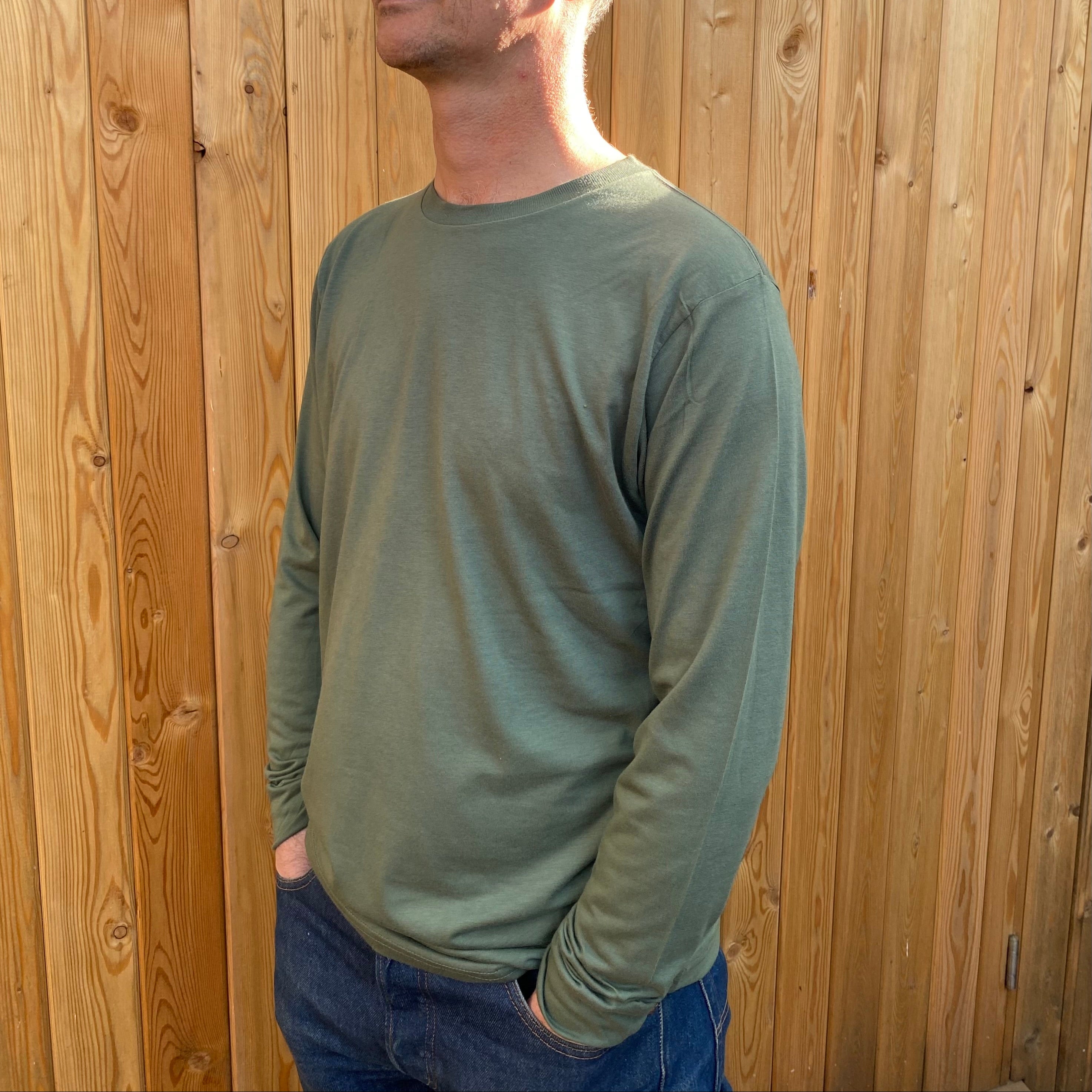 A man in a long sleeve olive tshirt