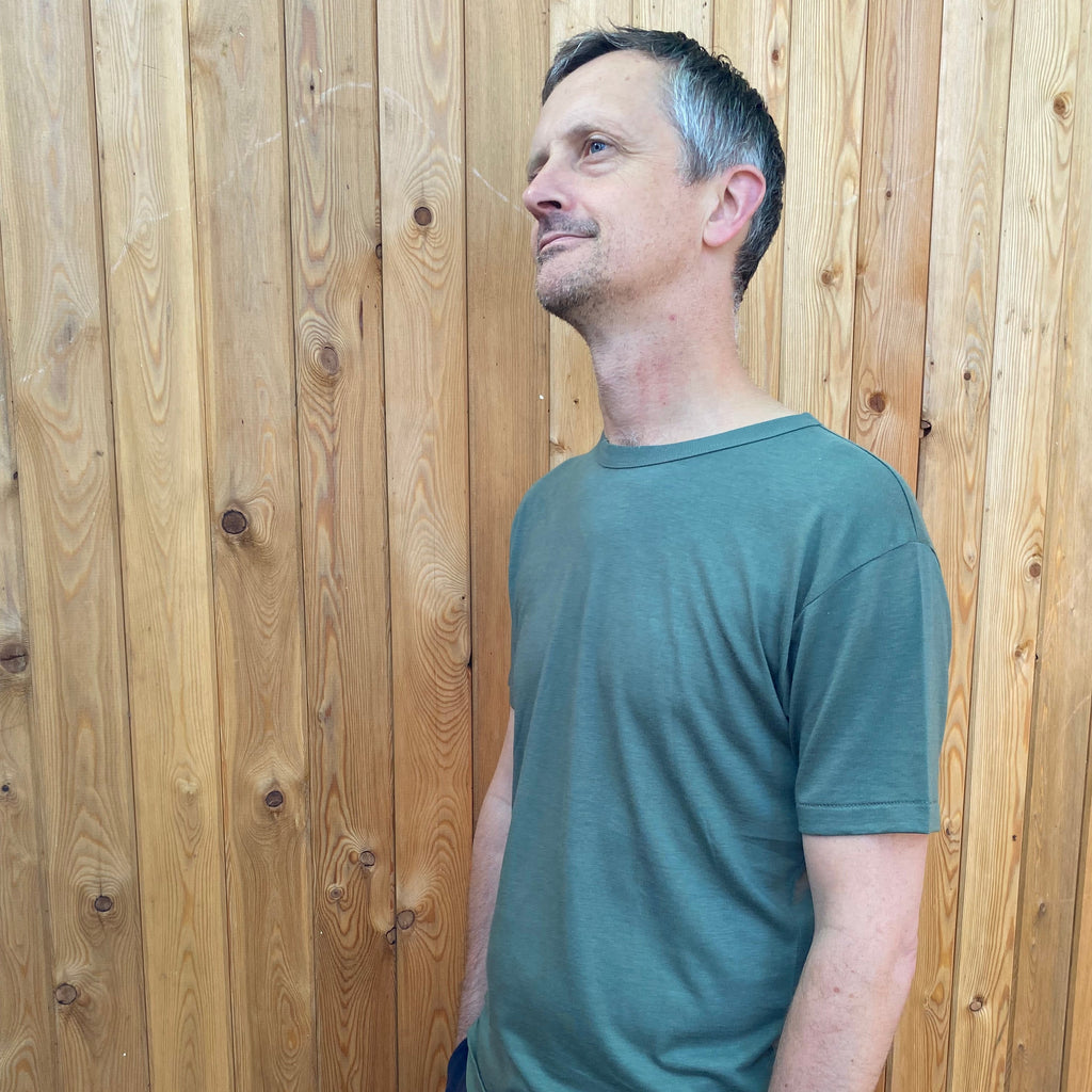 a man wearing an olive t shirt