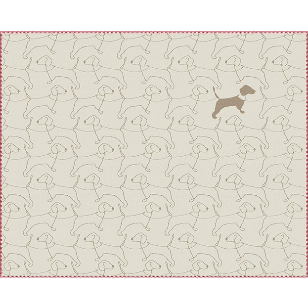 A rectangular blanket with an allover repeating pattern of beige dog silhouettes outlined in brown, plus a larger solid brown dog silhouette near the upper right. The item has a thin pinkish-red stitched border and is shown flat against a white background.