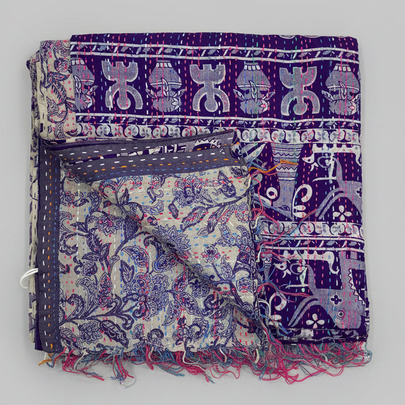 Decorative fabric with intricate patterns and fringes on a beige background