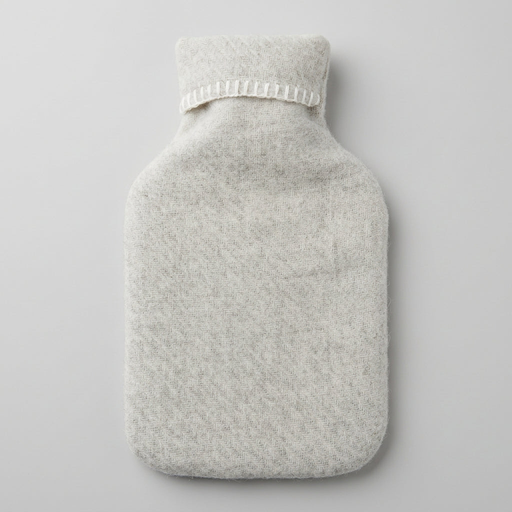 hot water bottle in cream wool cover
