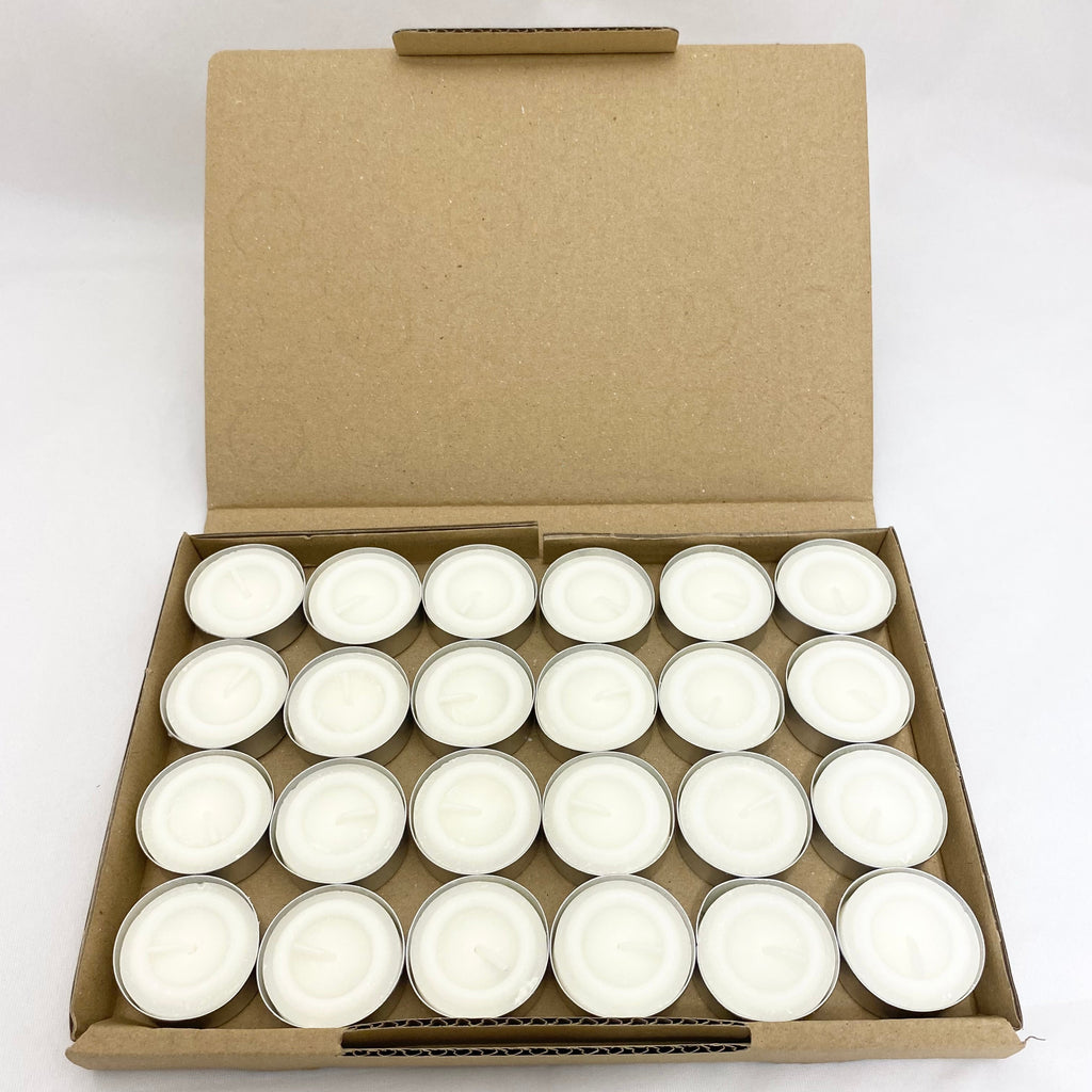 A cardboard tray filled with 20 small white tea light candles, shown with the lid open against a plain white background.