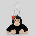 Plush monkey keychain with a red emblem on a white background