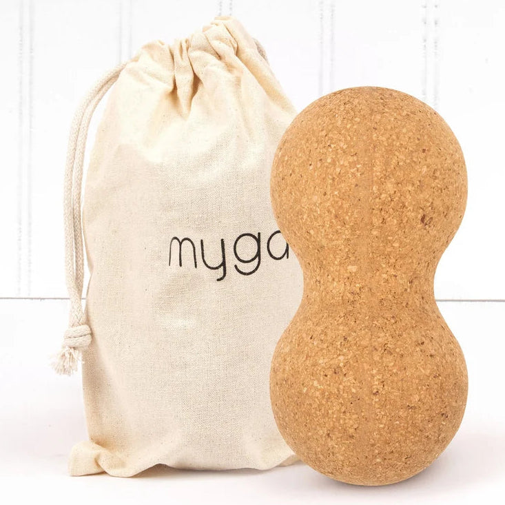 Cork yoga peanut with a 'myga' branded drawstring bag on a white background