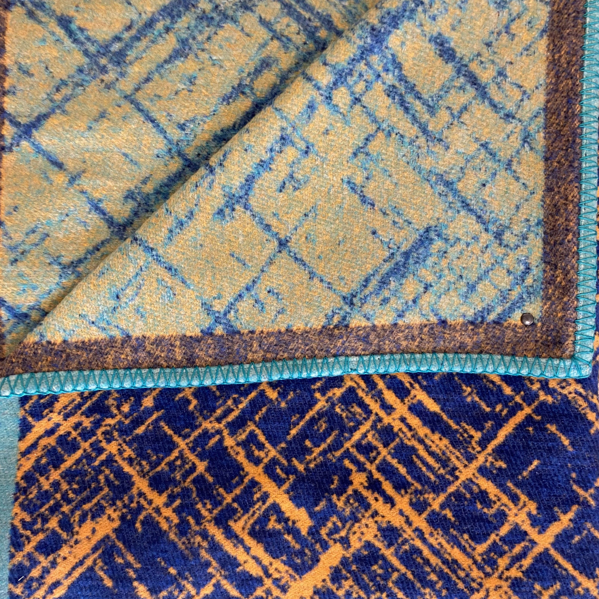 reversable blanket dark blue with orange random line and the otherside is pale orange with pale blue random lines