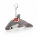Plush shark keychain with a tag on a white background
