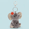 Plush elephant keychain with a silver ring and red tag on a white background