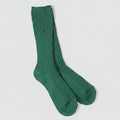 Green sock on a light gray background