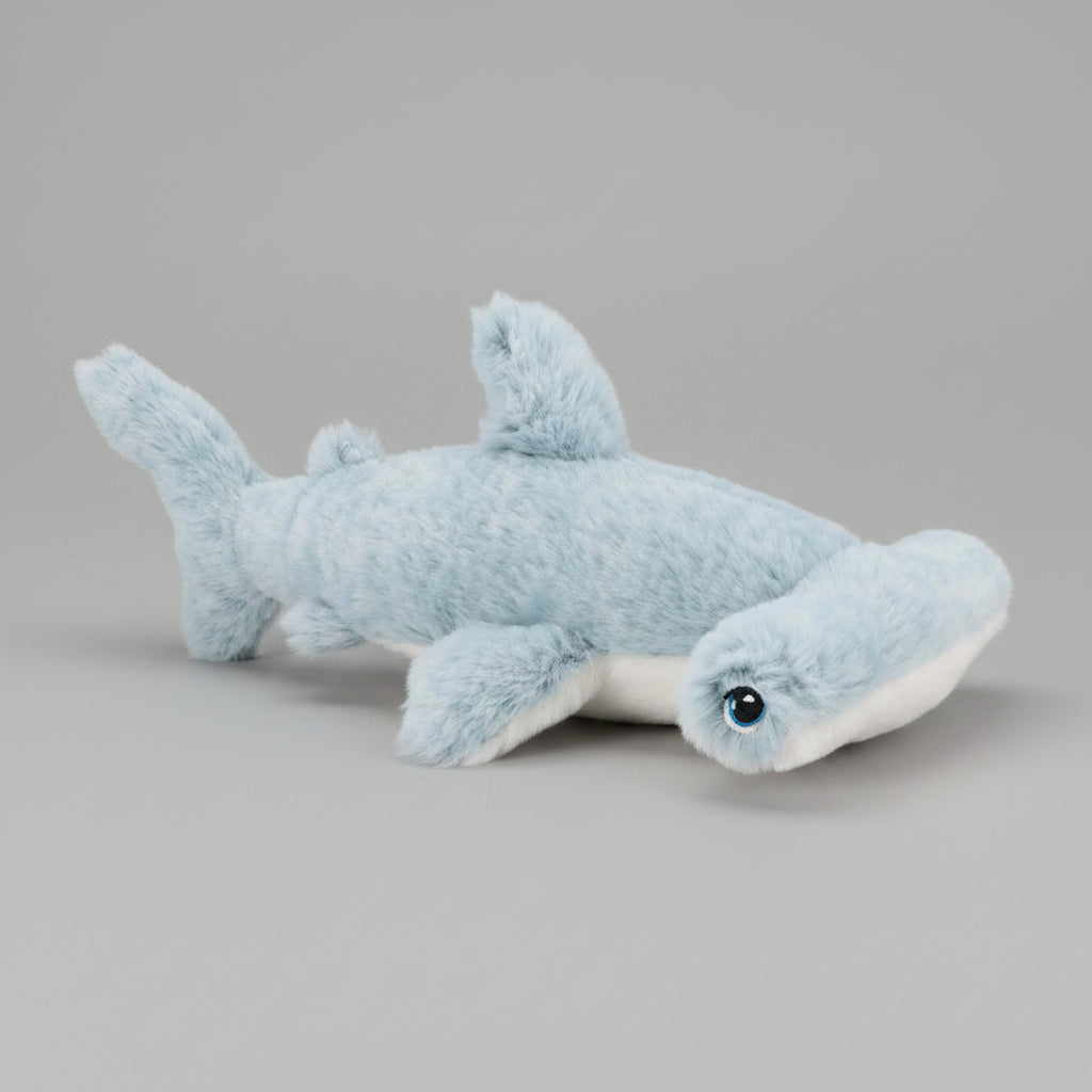 Plush shark toy on a grey background