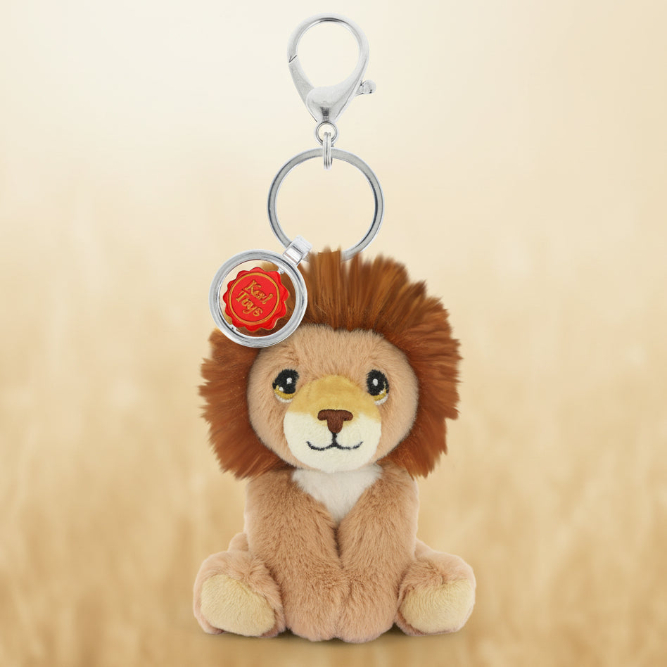 Plush lion keychain with a red emblem on a white background
