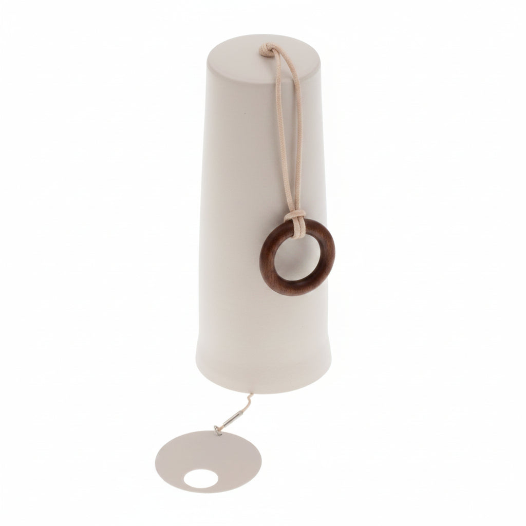 A minimalist white metal wind chime featuring a tapered cylindrical body, a natural wood ring hanging from the top, and a round metal striker at the bottom, shown against a solid white background.