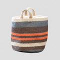 A woven jute basket with a striped pattern in blue-gray, brown, cream, and orange, featuring two natural jute handles, shown against a plain white background.