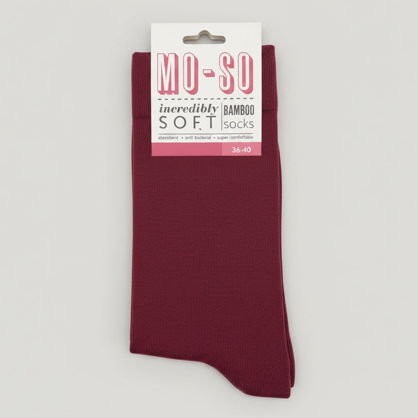 a pair of claret mo-so socks on a grey background