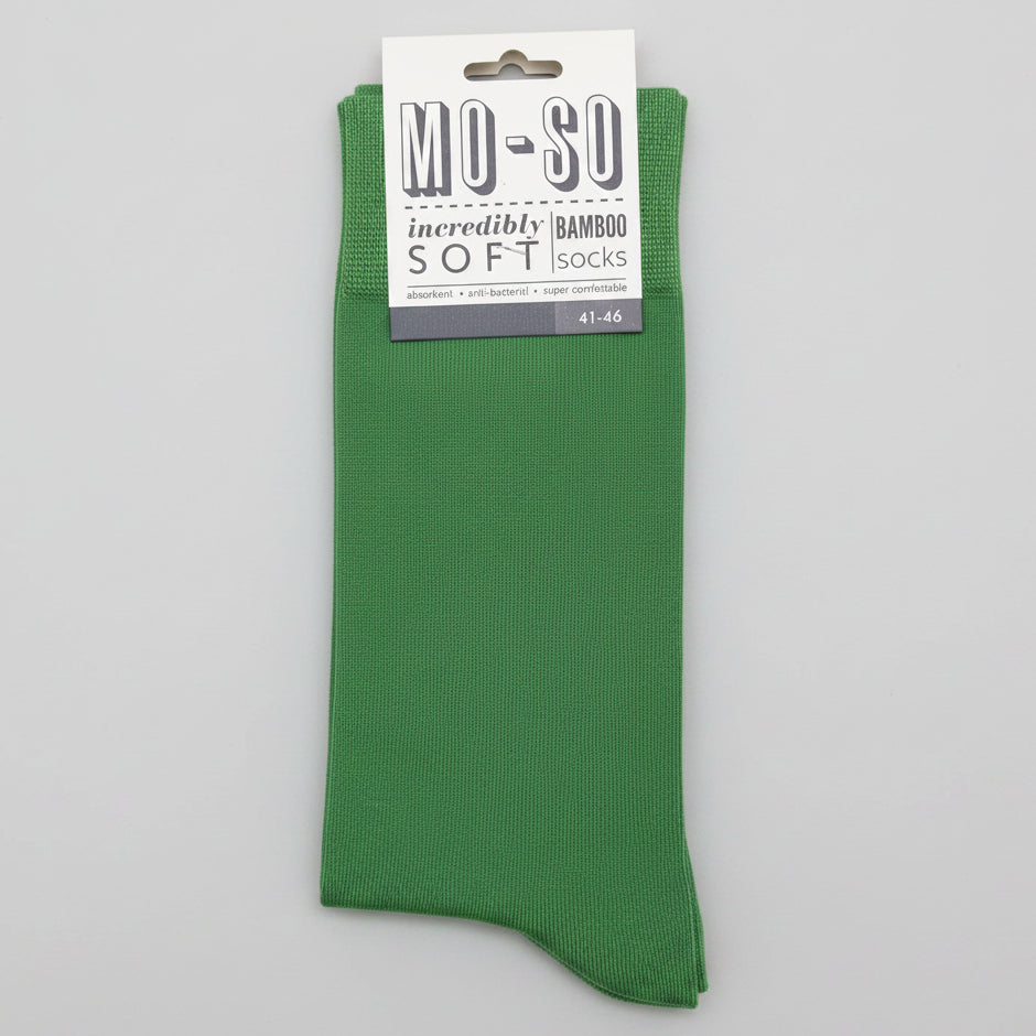 a pair of green mo-so socks 7-11 on a grey background