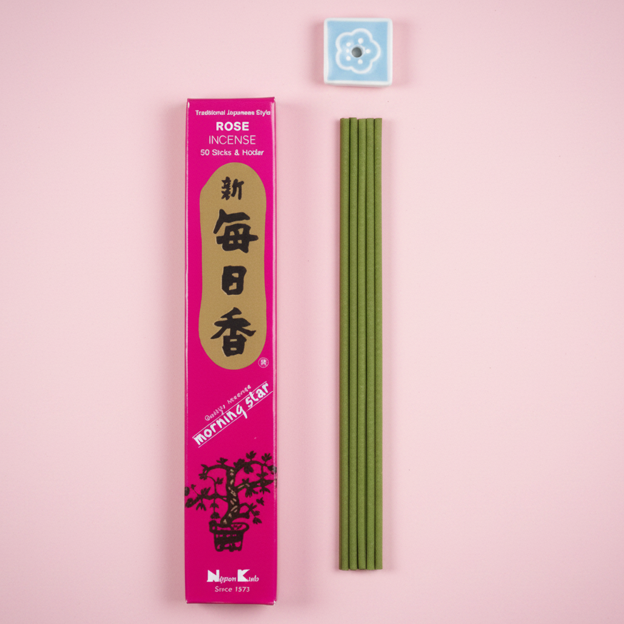 Incense sticks with packaging on a pink background