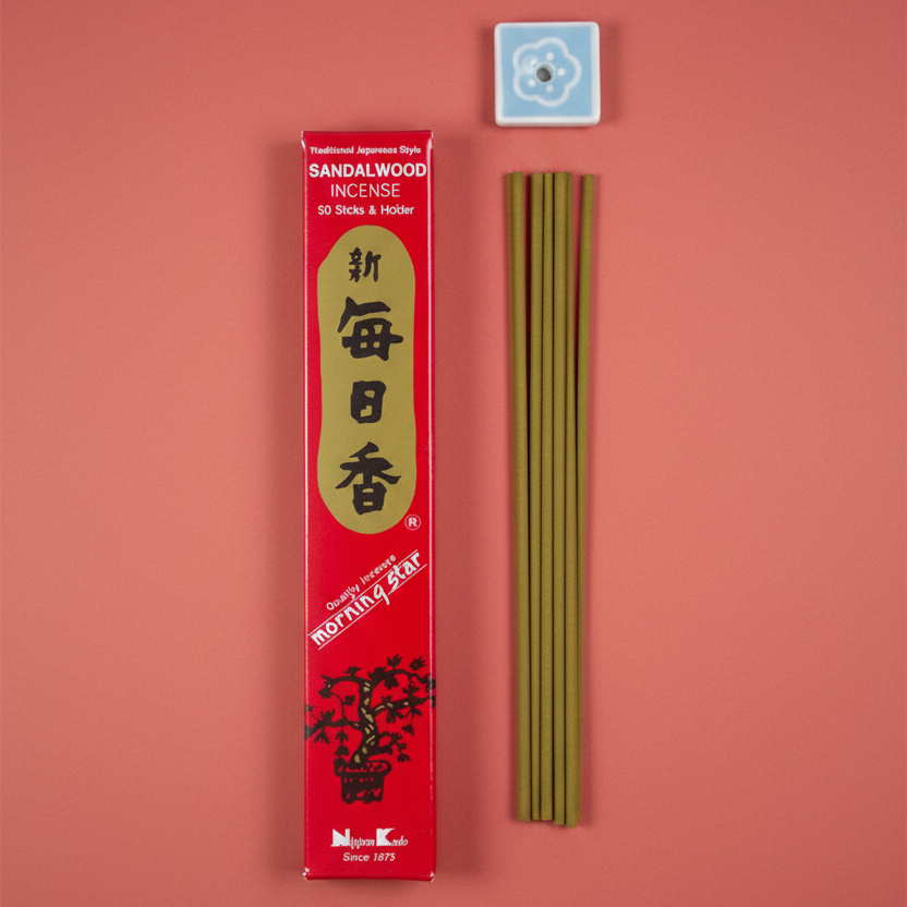 Sandalwood incense sticks with packaging on a rose colour background