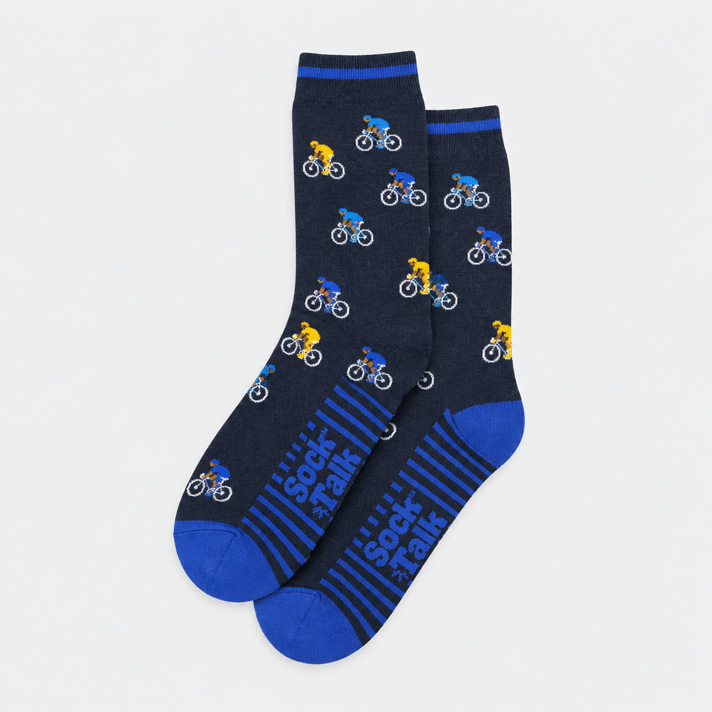 A pair of dark heather gray crew socks with a repeating pattern of small cyclists in blue, yellow, and white, featuring blue stripes and 'Sock Rails' text on the foot.