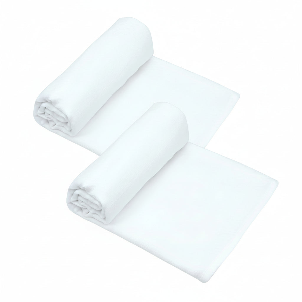 Two white baby swaddles arranged on a plain grey background.