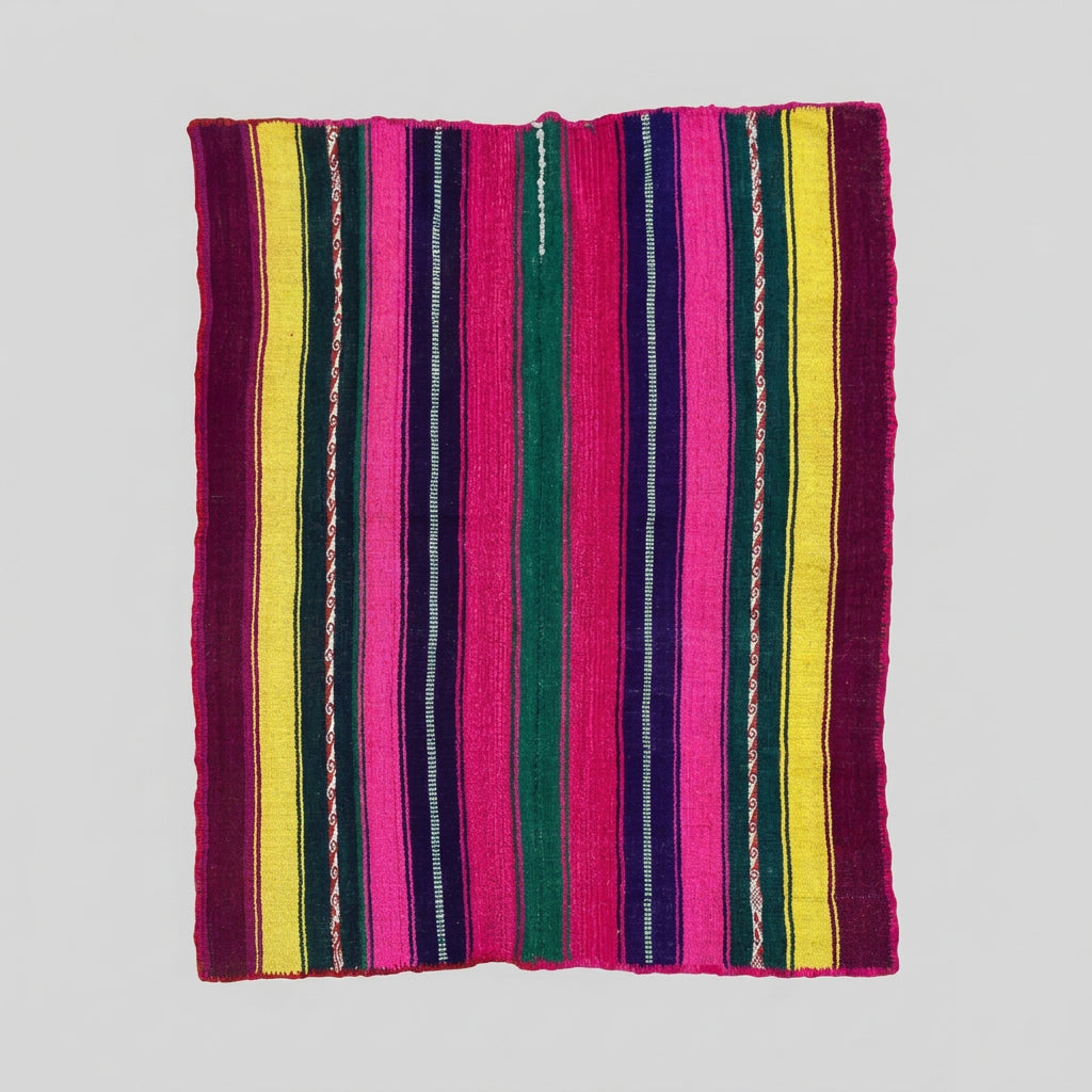 A colorful striped textile blanket or rug laid flat on a light wood floor, featuring vertical bands of magenta, yellow, green, navy, and white.