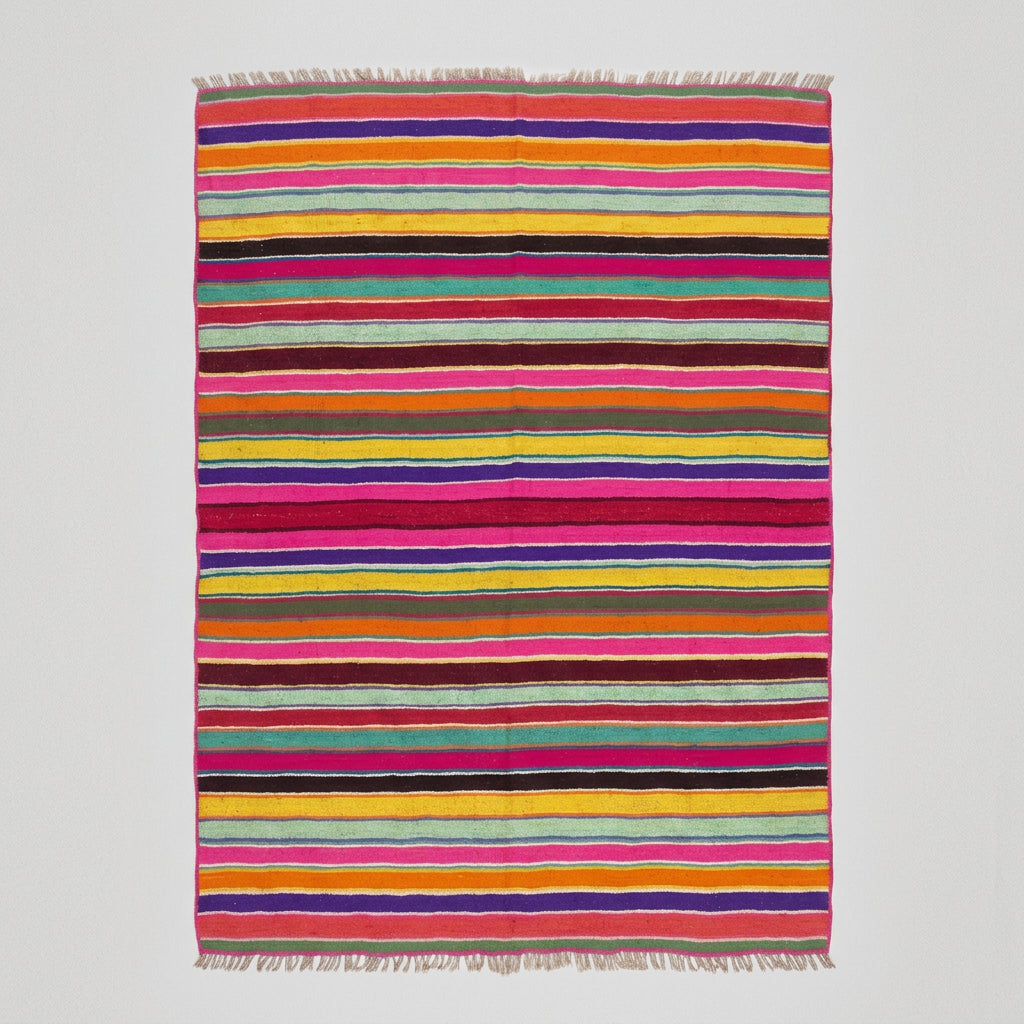 A large rectangular striped blanket or rug with horizontal bands of pink, red, orange, yellow, green, blue, and brown.