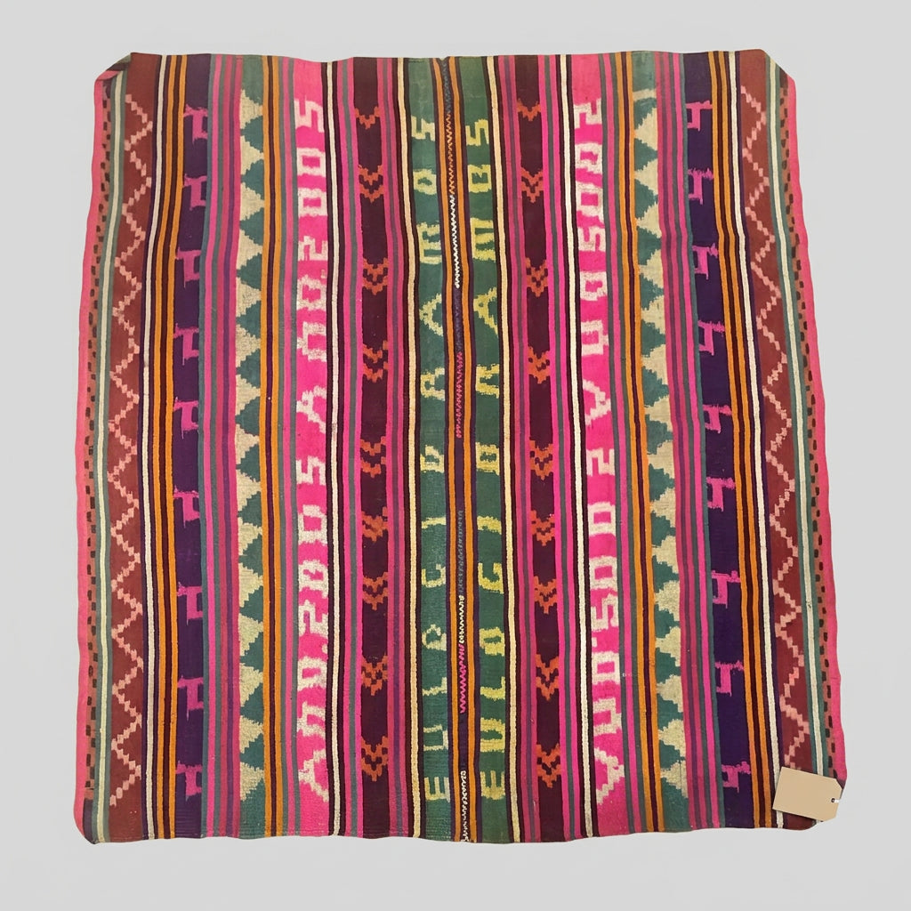 A colorful woven area rug with vertical stripes and geometric patterns in pink, red, orange, yellow, green, and purple.