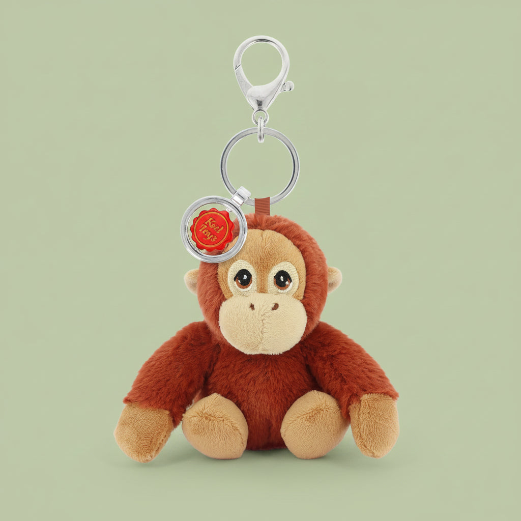 Plush orangutan keychain with a rose charm on a white background