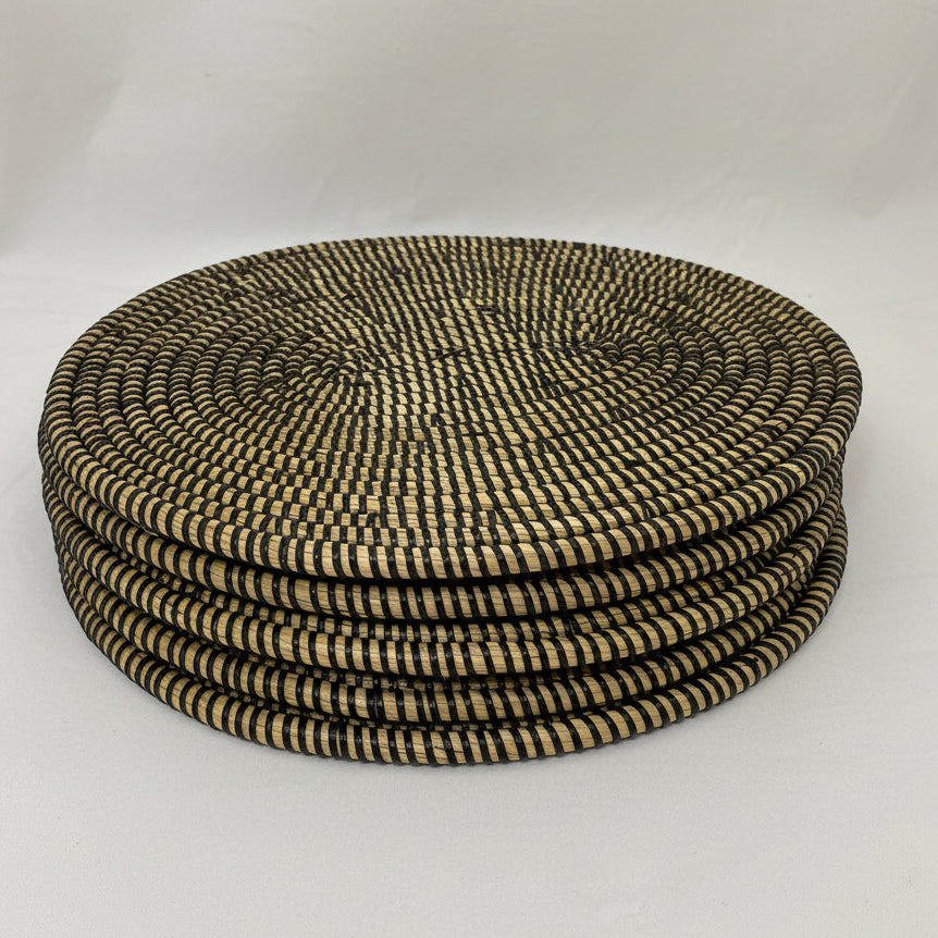 A oval woven placemat with a tight basketweave pattern. 