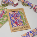 Packaged colorful fabric with floral patterns on a wooden board