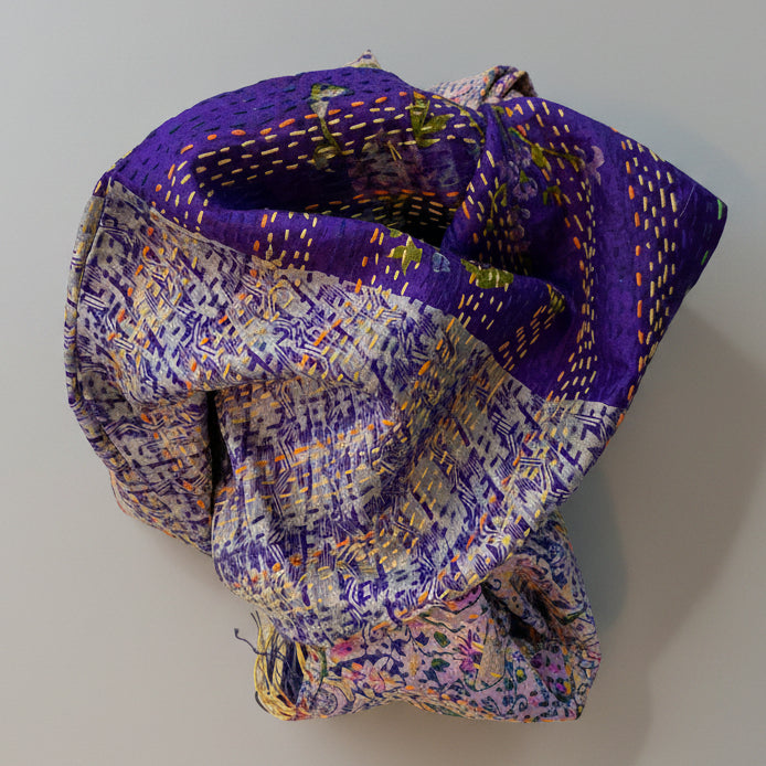 A purple silk sari scarf with floral patterns and kantha stitching, displayed on a neutral background.